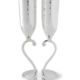 A pair of champagne glasses that when placed togetehr make a heart
